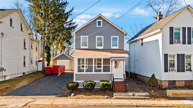 front of property featuring a garage and an outdoor structure