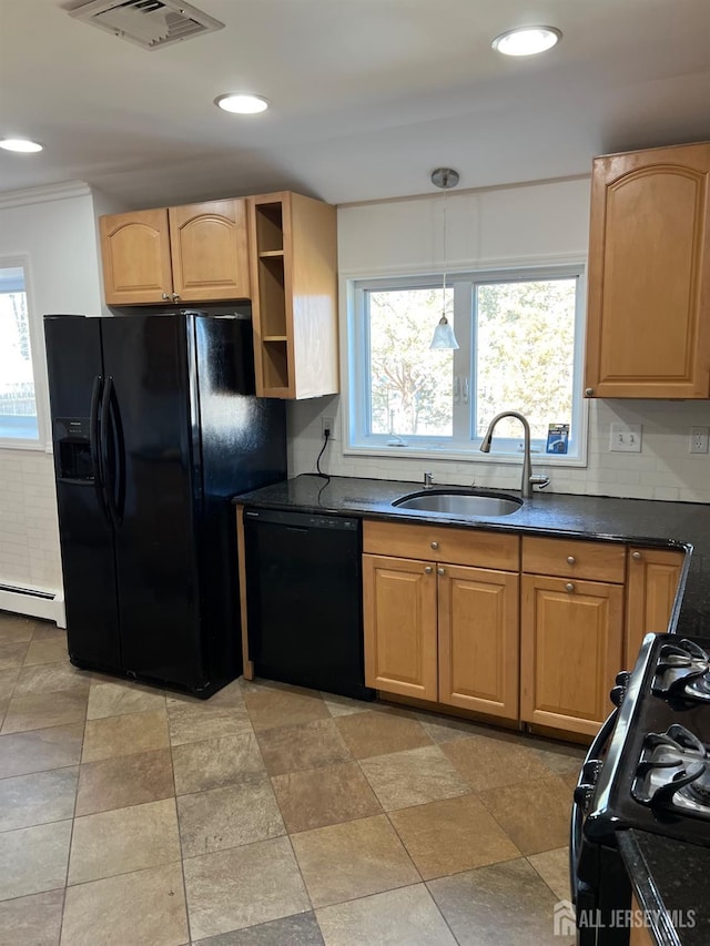 kitchen with hanging light fixtures, black appliances, sink, backsplash, and a baseboard radiator