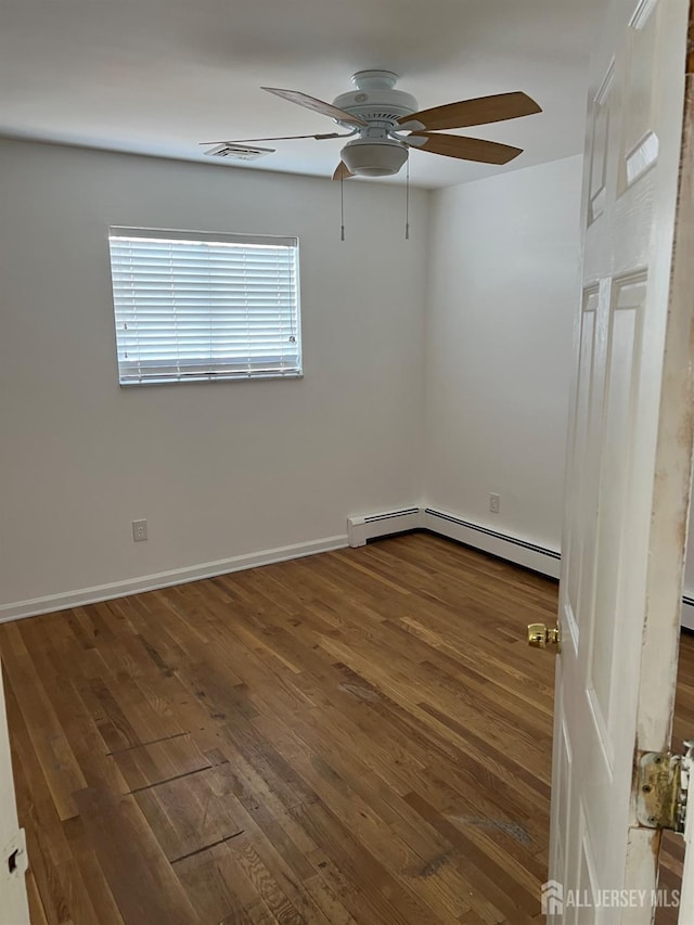 empty room with ceiling fan, dark wood-type flooring, and a baseboard radiator