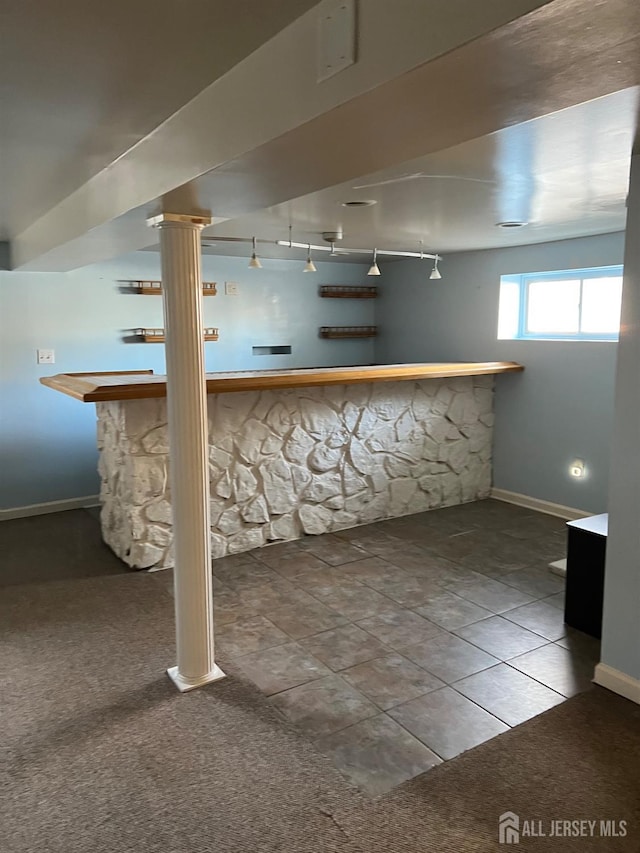 basement with carpet flooring and indoor bar