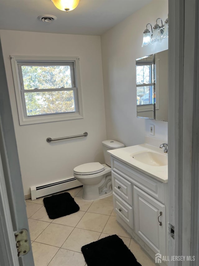 bathroom with toilet, vanity, tile patterned flooring, and a baseboard radiator