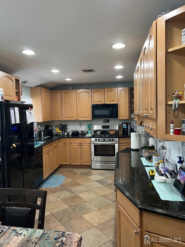 kitchen with black appliances and dark stone countertops