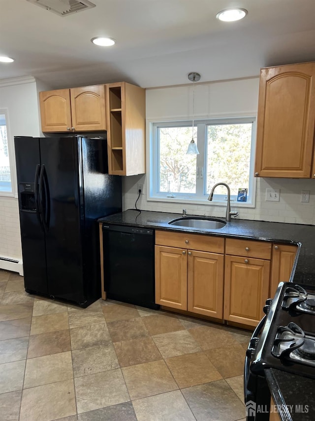 kitchen with sink, black appliances, a healthy amount of sunlight, and a baseboard heating unit