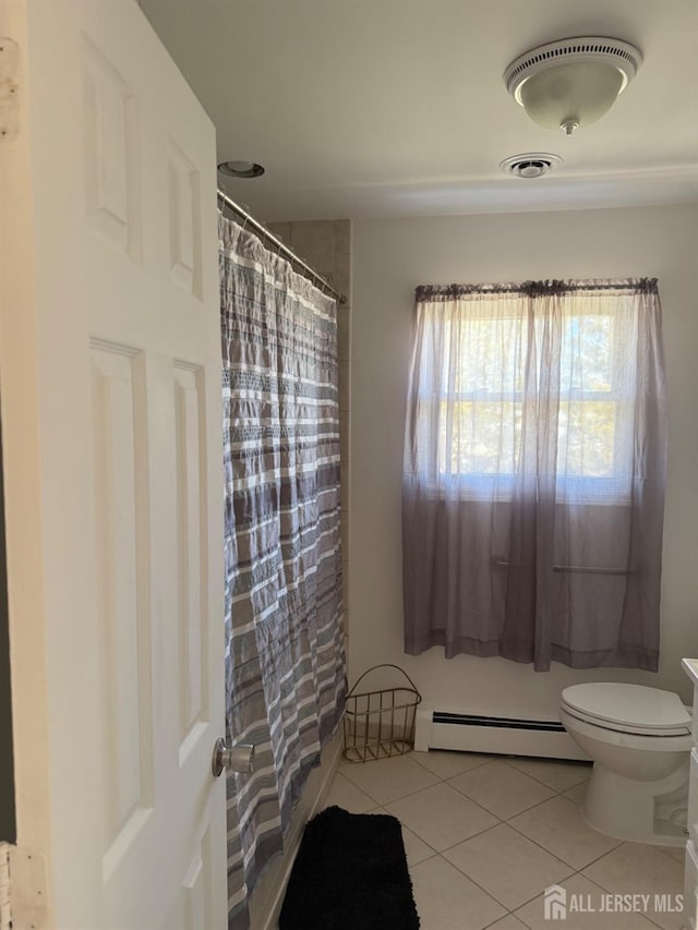 24 Kensington Ave, Old Bridge, NJ 08857 - full bathroom featuring a baseboard heating unit, tile patterned flooring, toilet, and a shower with shower curtain