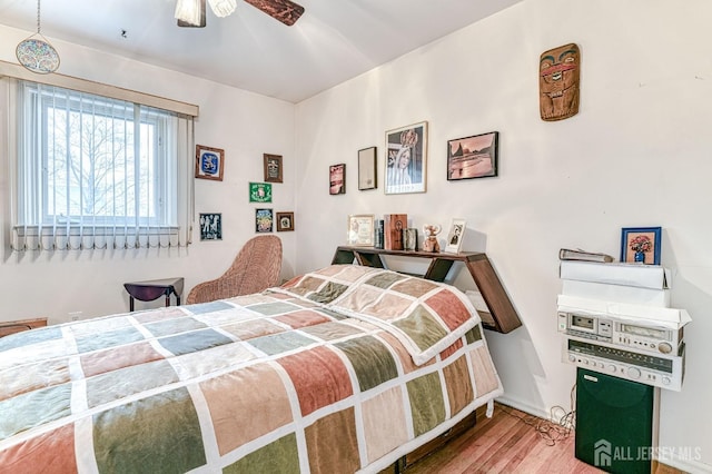 bedroom featuring a ceiling fan and wood finished floors