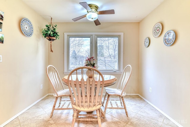 dining space featuring light tile patterned flooring, baseboards, and ceiling fan