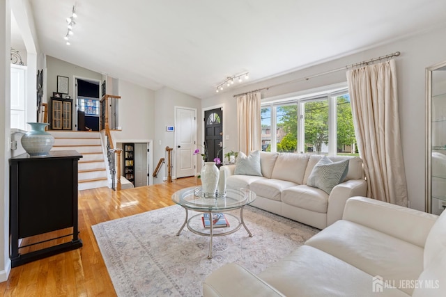 27 York St, Old Bridge, NJ 08857 - living room with rail lighting, vaulted ceiling, light wood finished floors, and stairway