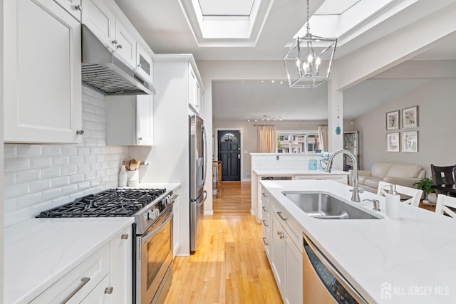 27 York St, Old Bridge, NJ 08857 - kitchen with stainless steel appliances, white cabinets, light wood finished floors, and backsplash