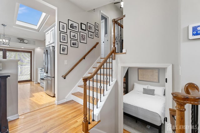 27 York St, Old Bridge, NJ 08857 - staircase featuring wood finished floors, a skylight, and a chandelier
