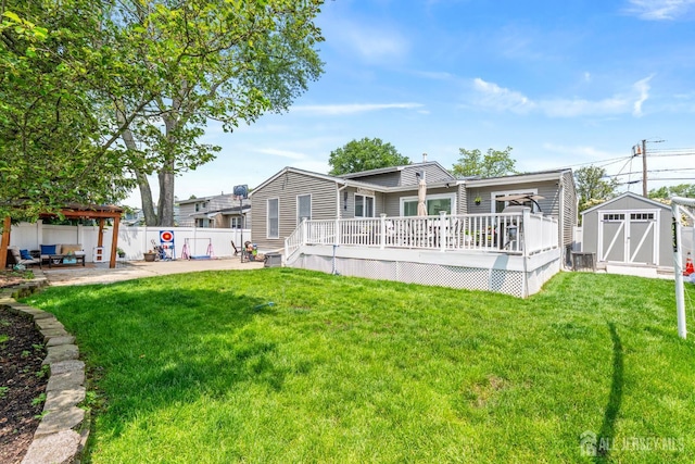 27 York St, Old Bridge, NJ 08857 - back of property featuring a storage unit, a wooden deck, and a patio area