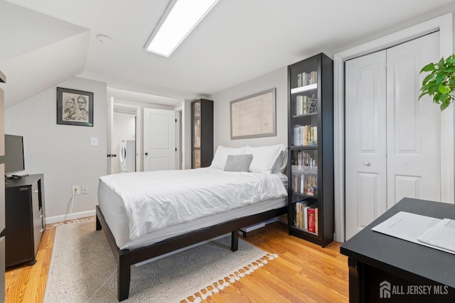 27 York St, Old Bridge, NJ 08857 - bedroom featuring washer / clothes dryer, a closet, light wood-style floors, and vaulted ceiling