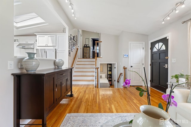 27 York St, Old Bridge, NJ 08857 - foyer featuring vaulted ceiling, rail lighting, light wood-style floors, and stairs