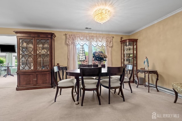 dining room featuring carpet floors, a chandelier, and crown molding