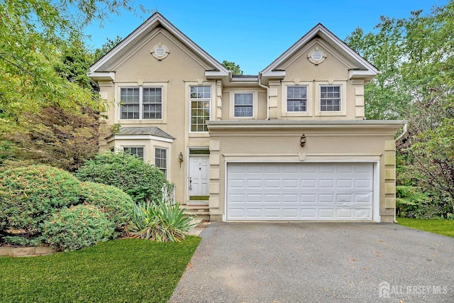 37 Walden Ct, Old Bridge, NJ 08857 - view of front facade with stucco siding, driveway, and a garage