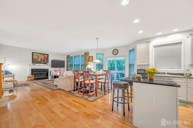 37 Walden Ct, Old Bridge, NJ 08857 - dining room featuring a glass covered fireplace, light wood-style floors, and recessed lighting