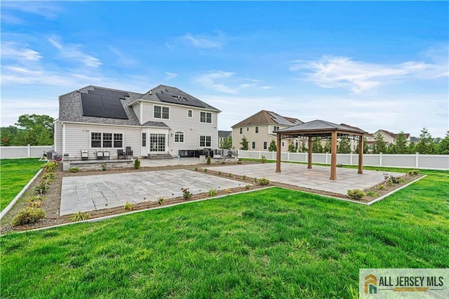 153 Scarborough Rd, Montgomery, NJ 08502 - back of property featuring a gazebo, a patio area, roof mounted solar panels, and central AC unit