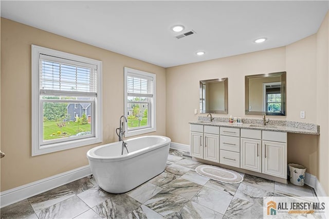 153 Scarborough Rd, Montgomery, NJ 08502 - bathroom with double vanity, baseboards, a freestanding tub, and recessed lighting