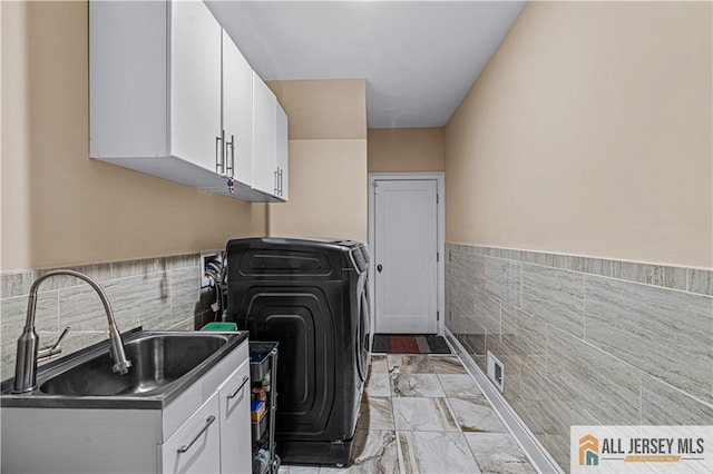 153 Scarborough Rd, Montgomery, NJ 08502 - laundry room featuring cabinet space, tile walls, light marble finish flooring, wainscoting, and independent washer and dryer
