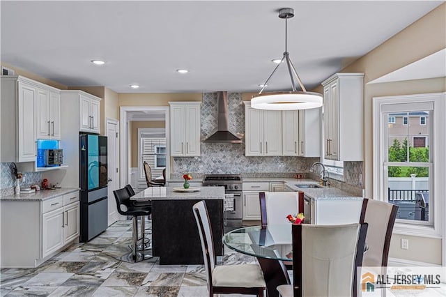 153 Scarborough Rd, Montgomery, NJ 08502 - kitchen featuring wall chimney range hood, stainless steel stove, a sink, a breakfast bar area, and tasteful backsplash
