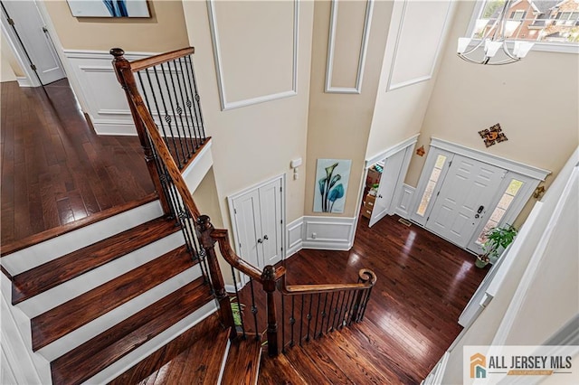 153 Scarborough Rd, Montgomery, NJ 08502 - foyer featuring a high ceiling, hardwood / wood-style flooring, a chandelier, wainscoting, and a decorative wall