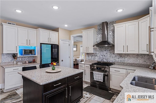 153 Scarborough Rd, Montgomery, NJ 08502 - kitchen featuring wall chimney exhaust hood, stainless steel range, white cabinetry, decorative backsplash, and recessed lighting