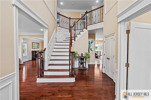 153 Scarborough Rd, Montgomery, NJ 08502 - foyer entrance featuring ornamental molding, wood finished floors, stairs, plenty of natural light, and wainscoting