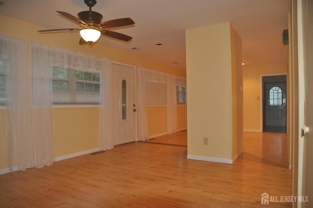 spare room featuring baseboards, a ceiling fan, and wood finished floors