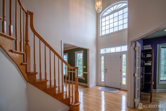 13 Carnegie St, Monroe, NJ 08831 - foyer featuring a high ceiling, light wood-style floors, stairway, and a chandelier