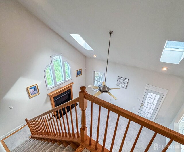 13 Carnegie St, Monroe, NJ 08831 - stairway featuring a skylight, a fireplace, carpet flooring, recessed lighting, and high vaulted ceiling