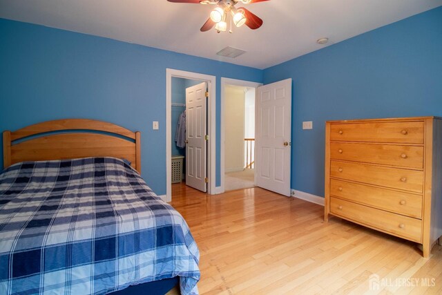 13 Carnegie St, Monroe, NJ 08831 - bedroom with wood finished floors, a ceiling fan, and a walk in closet