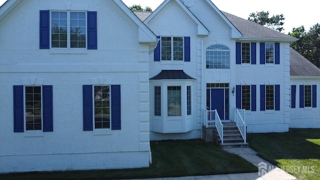 13 Carnegie St, Monroe, NJ 08831 - view of front facade with a shingled roof and a front lawn
