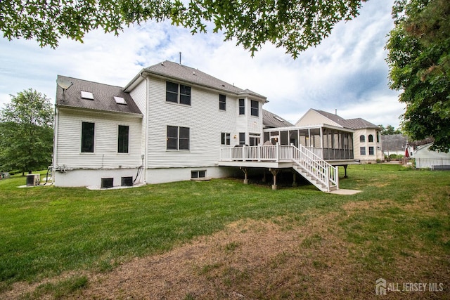 13 Carnegie St, Monroe, NJ 08831 - back of house with a sunroom, a lawn, and stairway