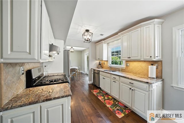 1072 Lake Placid Dr, Toms River, NJ 08753 - kitchen with exhaust hood, stainless steel appliances, a chandelier, and tasteful backsplash