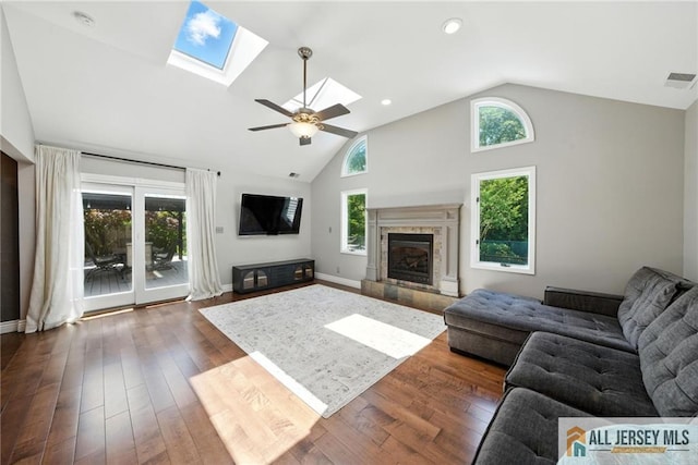 1072 Lake Placid Dr, Toms River, NJ 08753 - living area with a skylight, plenty of natural light, a fireplace, dark wood finished floors, and high vaulted ceiling