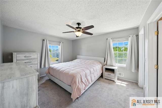 1072 Lake Placid Dr, Toms River, NJ 08753 - bedroom featuring multiple windows, a textured ceiling, light carpet, and ceiling fan