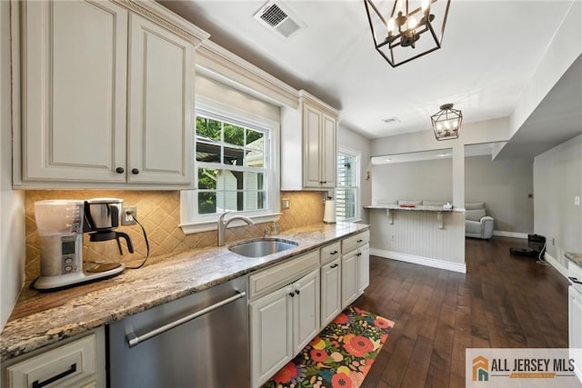 1072 Lake Placid Dr, Toms River, NJ 08753 - kitchen featuring stainless steel dishwasher, a chandelier, dark wood-style floors, light stone countertops, and tasteful backsplash