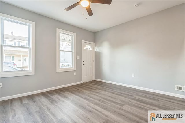 foyer entrance with ceiling fan and light hardwood / wood-style flooring