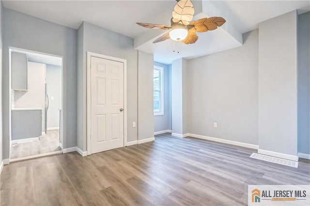 unfurnished bedroom featuring ceiling fan and wood-type flooring