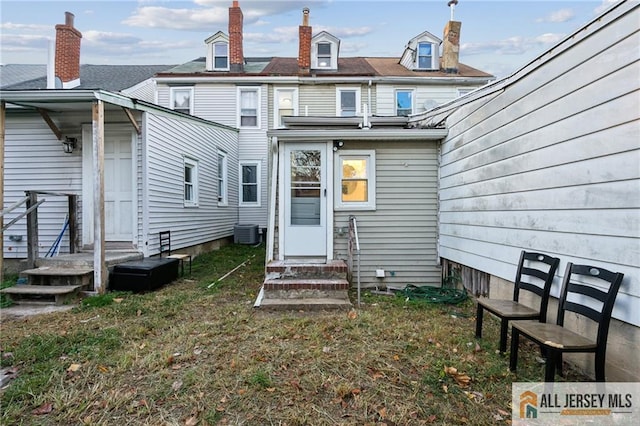 rear view of house featuring central air condition unit