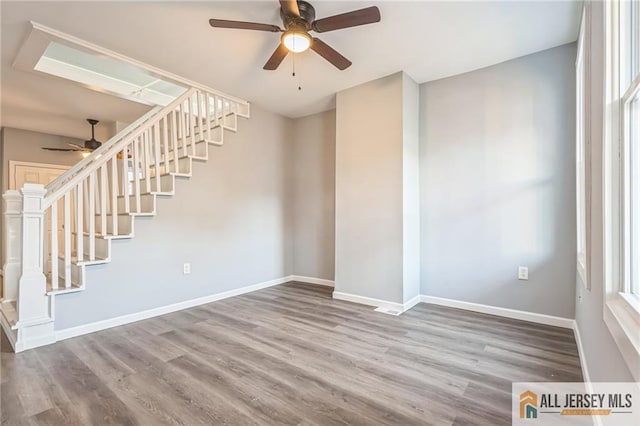 interior space with hardwood / wood-style floors and ceiling fan