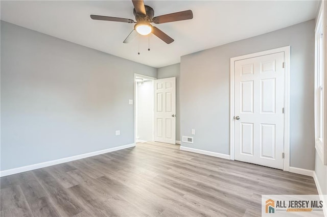 unfurnished bedroom with ceiling fan and light hardwood / wood-style flooring