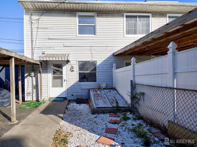 rear view of property featuring a fenced backyard