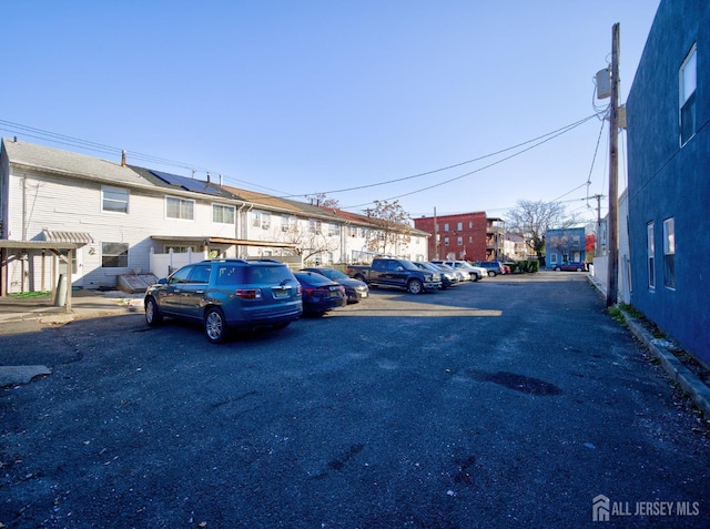 uncovered parking lot featuring a residential view