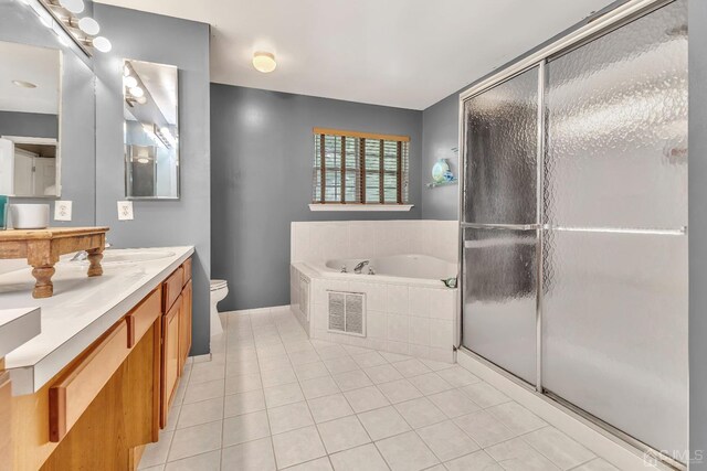 full bathroom with toilet, shower with separate bathtub, vanity, and tile patterned floors