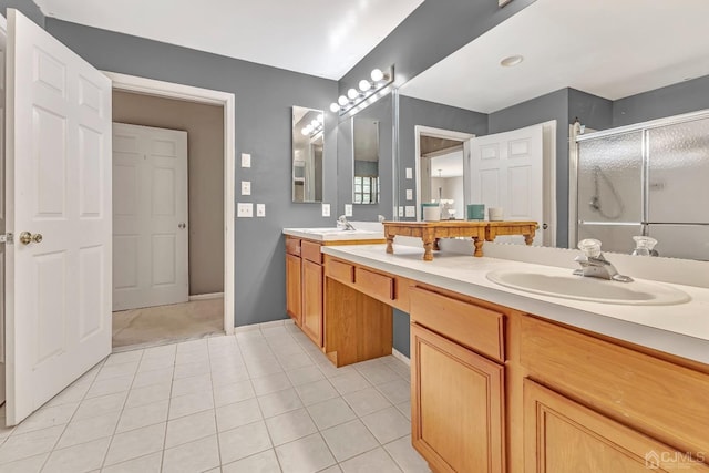 bathroom with vanity, tile patterned flooring, and a shower with shower door