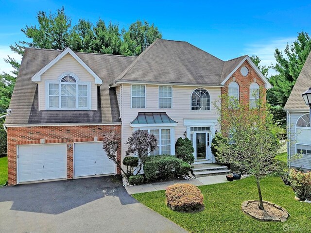 view of front of property with a front yard and a garage