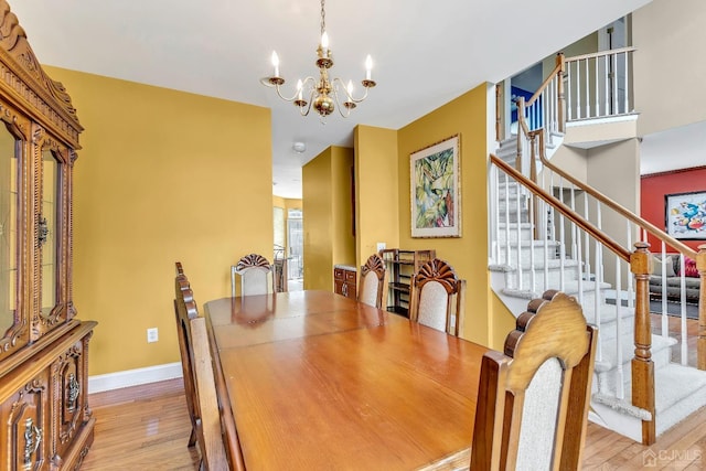 dining area featuring light hardwood / wood-style floors and a chandelier