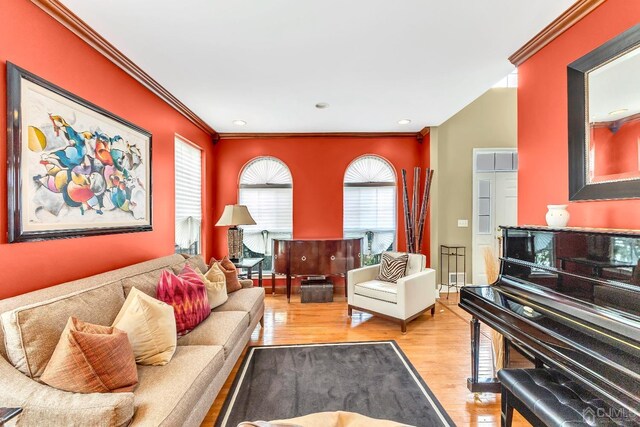 living room featuring crown molding and light hardwood / wood-style flooring