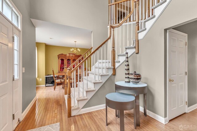 foyer with a notable chandelier and hardwood / wood-style floors