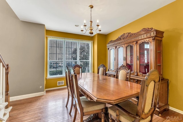 dining room featuring an inviting chandelier and light hardwood / wood-style floors